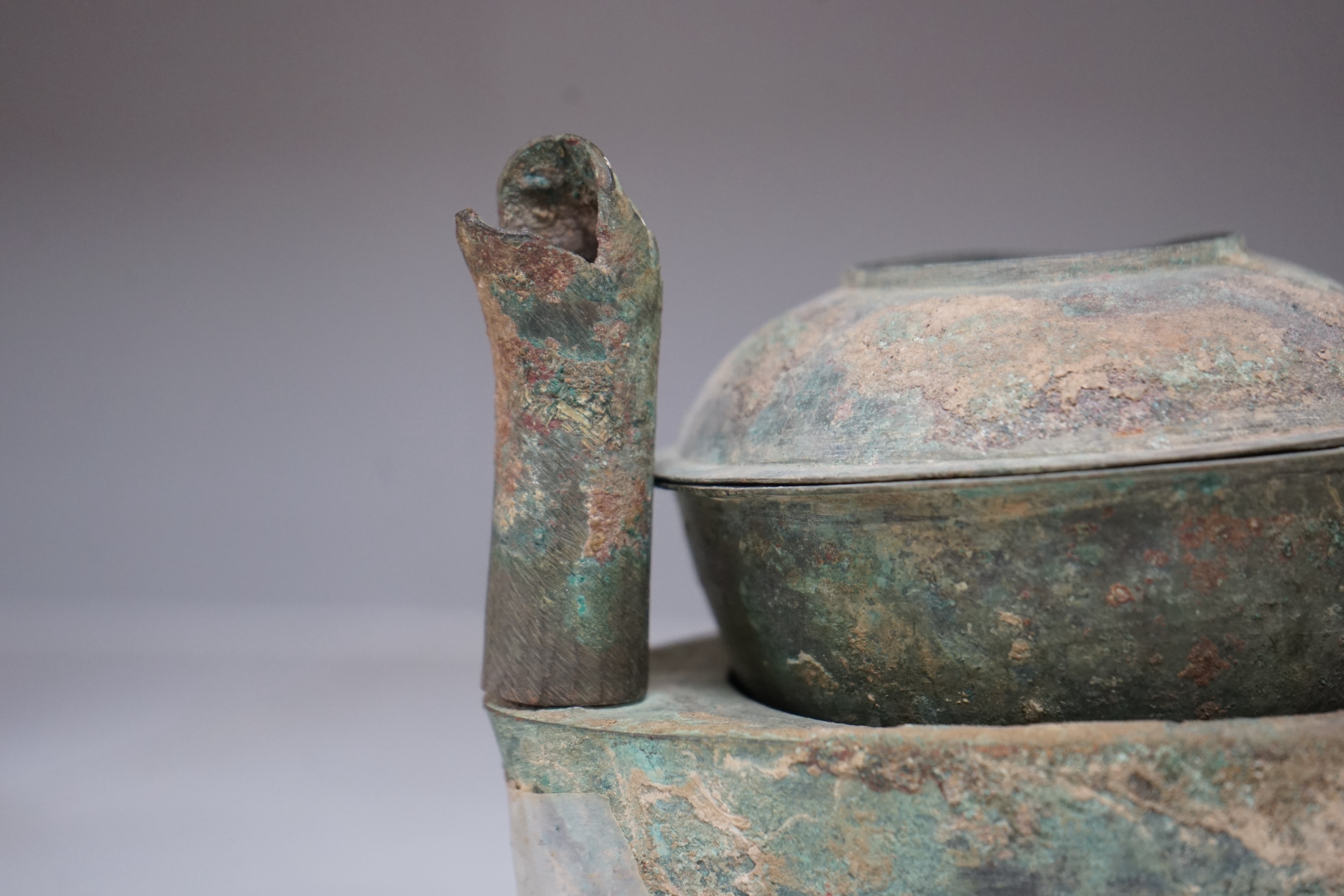 Four Chinese bronze zoomorphic stoves, Han Dynasty, 22cm, together with a Han Dynasty bronze brazier and vessels, width 22.5cm, (5). Condition - poor to fair.